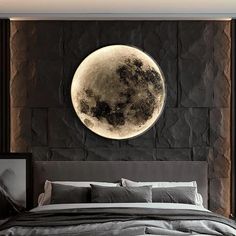 a large bed sitting under a giant moon on top of a wall