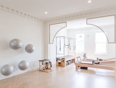 an empty room with some balls on the wall and other objects in the floor around it