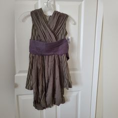 a woman's dress hanging on a door