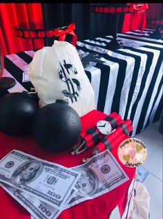 a table topped with money and black and white bags