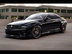 a black car parked in front of a building