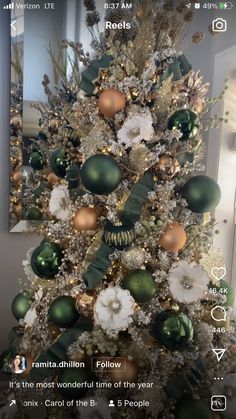 a christmas tree decorated with green, gold and white ornaments is featured in this instagram