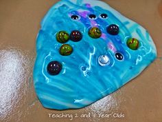 a close up of a rock with many different colored rocks on it and the words teach me and year olds written below