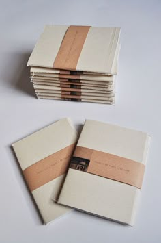 several folded books with brown paper on them