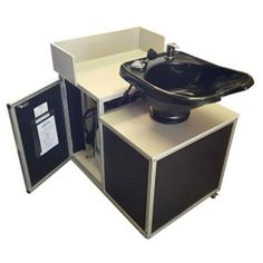 a black sink sitting on top of a white counter next to a cabinet with an open door