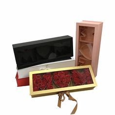 two open boxes with roses in them sitting next to each other