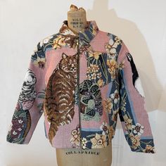 a mannequin wearing a colorful jacket with flowers on it