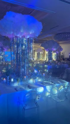 an indoor dining area with blue lighting and chandelier