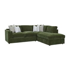 a green sectional couch with pillows on it's back and side facing the camera