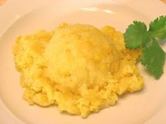 a white plate topped with mashed potatoes and cilantro