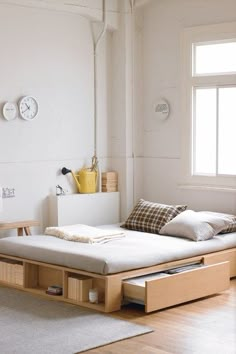 an image of a bed with drawers and lights on the bottom, in front of a window