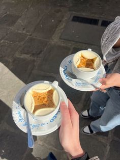 two people holding plates with food on them