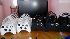 a bunch of video game controllers sitting on top of a wooden table next to a tv