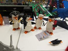 some lego penguins are standing next to each other