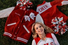 a cheerleader laying on the ground next to her uniform