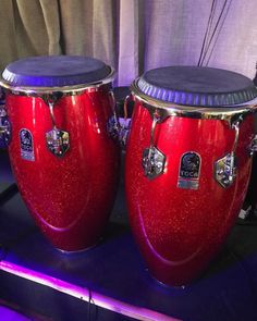 two red drums sitting on top of a table