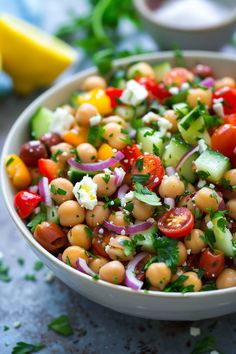 a white bowl filled with chickpeas and vegetables