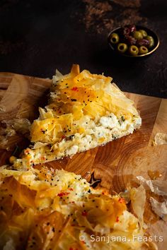 a wooden cutting board with some food on it