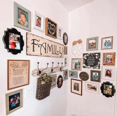 Celebrate your family with an eclectic photo display gallery wall. This gallery wall boasts a combination of family pictures and wall signs mounted to a white wall. A rustic wood and black metal coat rack is used to display a woven hanging flower basket...   Image: mysweetgeorgiahome