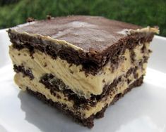 a close up of a piece of cake on a plate with grass in the background