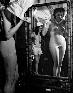 two women are standing in front of a mirror