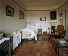 an old fashioned bedroom with antique furniture and decor