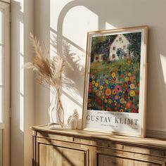 a painting on a dresser next to a window