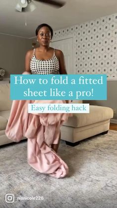 a woman standing in front of a couch with the words how to fold a fitted sheet like a pro