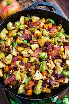 a skillet filled with potatoes, brussel sprouts and bacon