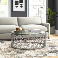 a living room scene with focus on the couch and coffee table in front of it