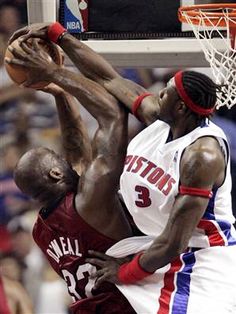 the basketball player is trying to dunk the ball