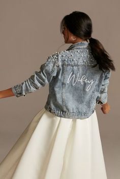 a woman in a white dress and jean jacket with the word wkny on it