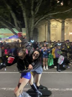 two people on skateboards in front of a crowd