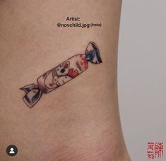 a small tattoo on the side of a woman's stomach shows an image of a roll of toilet paper