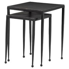 three black nesting tables with metal legs on each side and an open end table at the top