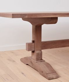 a wooden table sitting on top of a hard wood floor