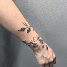 a person's arm with leaves on it