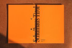 an orange notebook with the words hello sunshine written on it, sitting on a brown surface