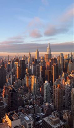 an aerial view of the city skyline at sunset