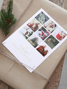 a wrapped present sitting on top of a wooden table next to a pine cone and twine