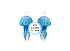 a pair of blue earrings with words on it