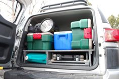 the back end of a truck filled with different types of plastic containers and water bottles