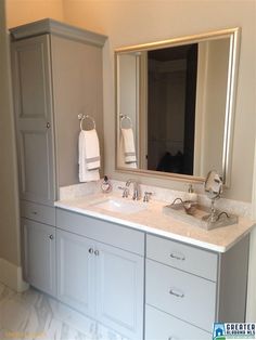 a bathroom with two sinks and a large mirror