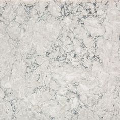 a white marble counter top with grey veining