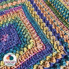 a crocheted blanket with multicolored squares on the top and bottom, in different colors