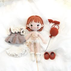 three crocheted dolls are laying next to each other on a white sheet,