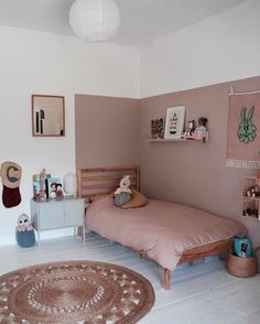 a bed room with a neatly made bed and stuffed animals