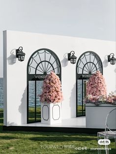 a white building with flowers in the windows