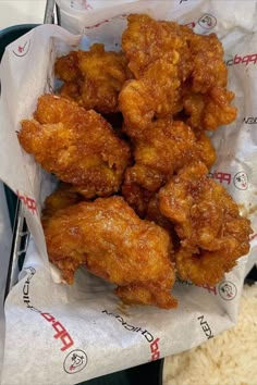 fried chicken in a basket with rice on the side