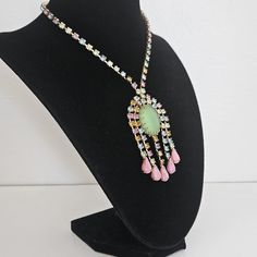 Colourful sparkling crystals arranged in a beautiful design.Elegant, chic waterfall design with colorful crystal with a large pear green central crystal. In good vintage condition. Please note, the size of the bust is smaller than average, and the necklace position on the body might differ from how it's pictured. For new arrivals check out the store's Instagram account https://www.instagram.com/helensjewellerybox/ All jewelry may have light scratches due to age. Thank you for looking and if you have any questions please don't hesitate to ask :) Waterfall Design, Elegant Chic, Sparkling Crystal, Vintage Crystal, Crystal Necklace, Instagram Account, Halloween Shopping, Favorite Jewelry, Beautiful Design